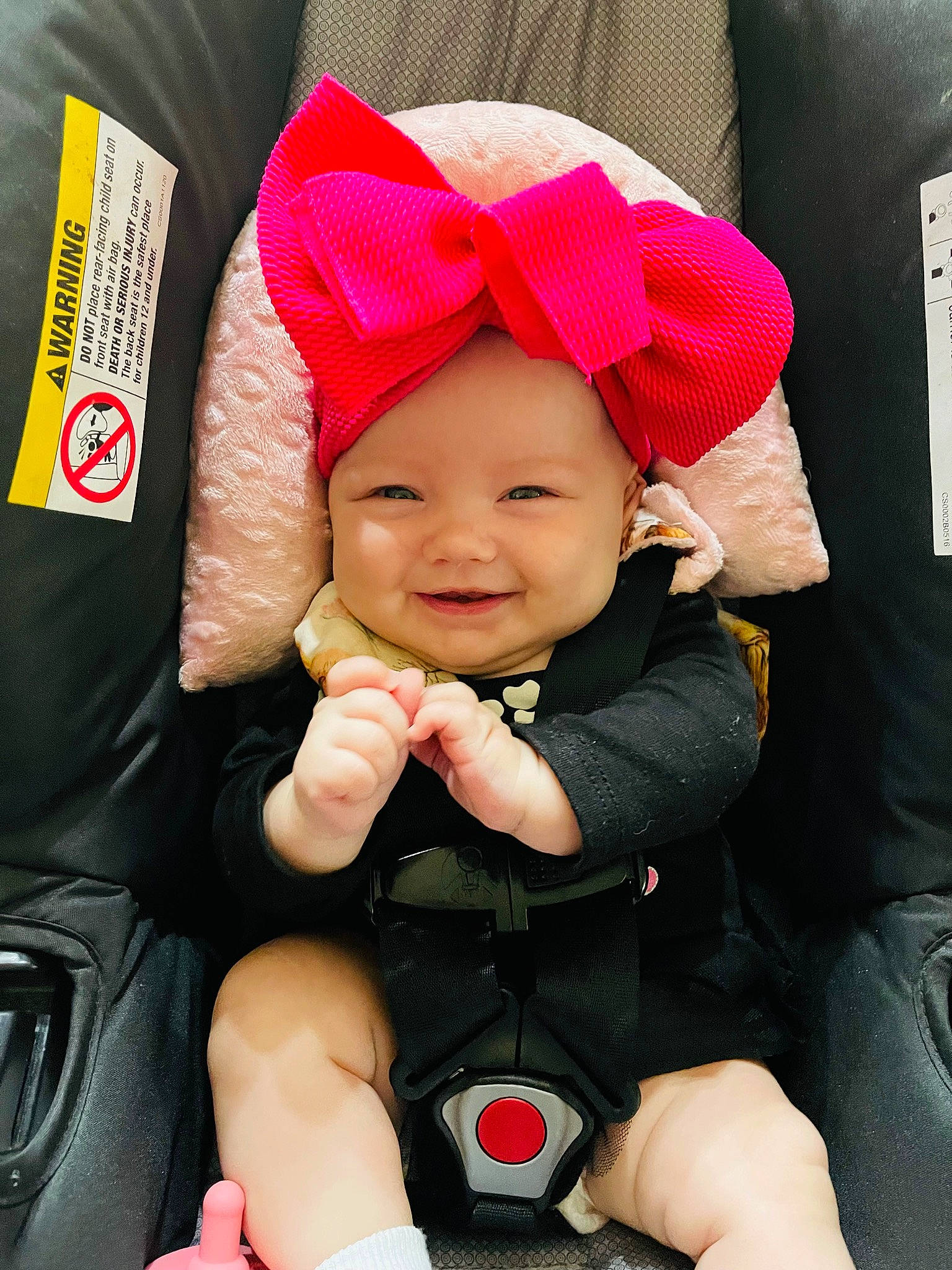 Ireland is registered to the contest to win money with this photo: baby, baby_carriage, baby_products, baby_toddler_clothing, cap, car_seat, cheek, comfort, eye, fashion_accessory, happy, hat, headwear, human_body, joy, magenta, person, pink, product, red