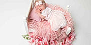 Gracie-Mae is registered to the contest to win money with this photo: baby, newborn, sleeping, pink, dress, headband, bed, pillow, blanket, flowers, fluffy, curly, white, soft, peaceful, infant, cute, portrait, studio, child