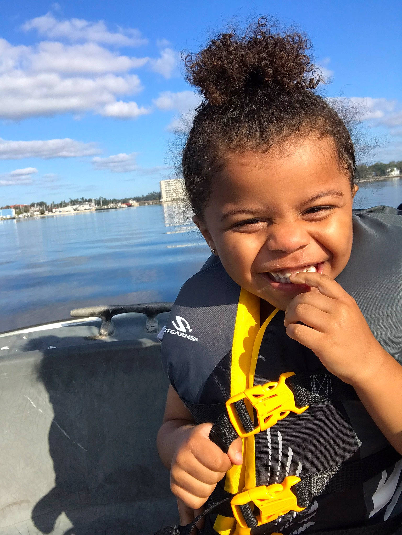Ahmir is registered to the contest to win money with this photo: beach, blue, cloud, cool, electric_blue, flash_photography, fun, gesture, happy, joy, lake, leisure, person, personal_protective_equipment, recreation, sky, sleeve, smile, thumb, toddler