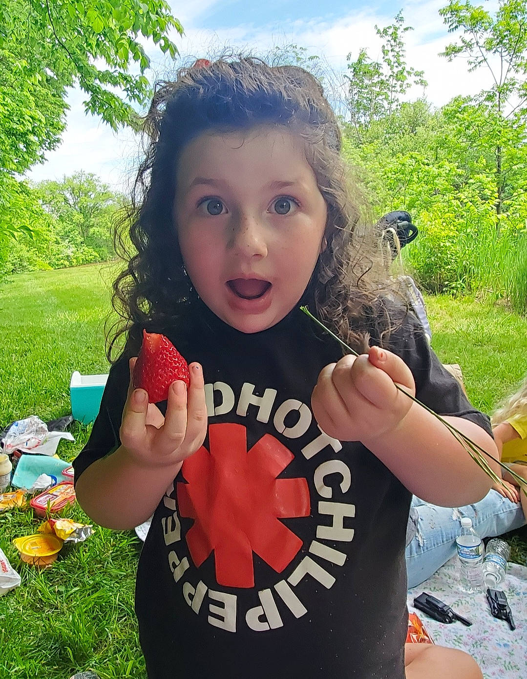 Mckenzie is registered to the contest to win money with this photo: child, finger, fun, gesture, grass, green, happy, leisure, people_in_nature, person, plant, play, recreation, sky, sleeve, soil, surprise, t_shirt, thumb, toddler