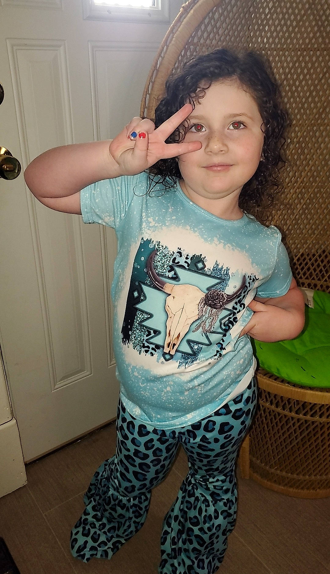 Mckenzie is registered to the contest to win money with this photo: baby_toddler_clothing, black_hair, child, cool, door, elbow, hair, hairstyle, happy, joy, neck, pattern, person, shoulder, sleeve, smile, standing, t_shirt, thigh, toddler