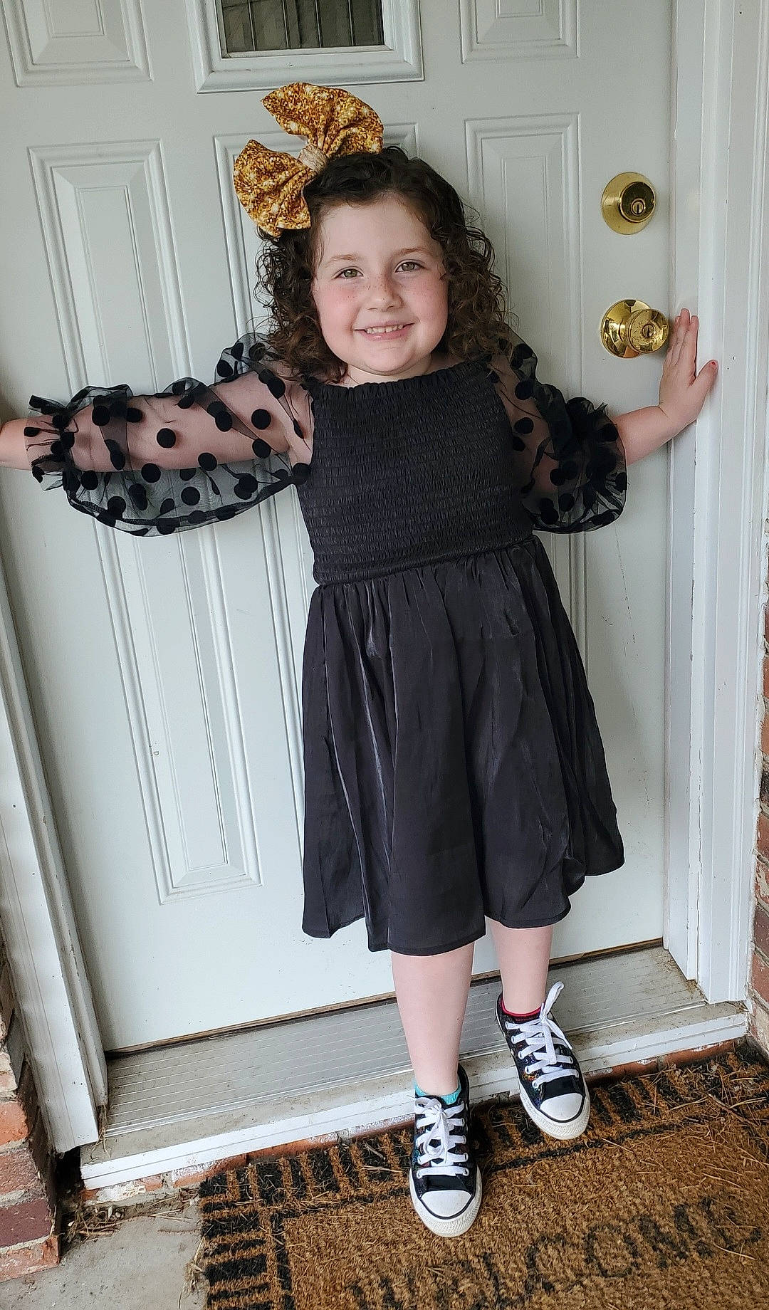 Mckenzie is registered to the contest to win money with this photo: black, blond, door, fashion_design, footwear, formal_wear, happy, human_leg, joint, joy, knee, pattern, person, shoe, shoulder, sleeve, smile, standing, textile, thigh