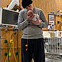 Rayleigh is registered to the contest to win money with this photo: baby, person, hospital, medical_equipment, crib, tender_moment, gray_sweater, black_hat, tattoos, affection, indoor, healthcare, monitor, wires, bed, patient_care, love, holding, kissing, newborn