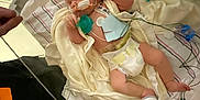 Rayleigh joined the competition — help win amazing prizes! infant, hospital, medical_equipment, crib, blanket, pacifier, wires, diaper, person, hand, tattoo, healthcare, monitoring, baby, bed, white_cloth, newborn, care, tubes, nursery