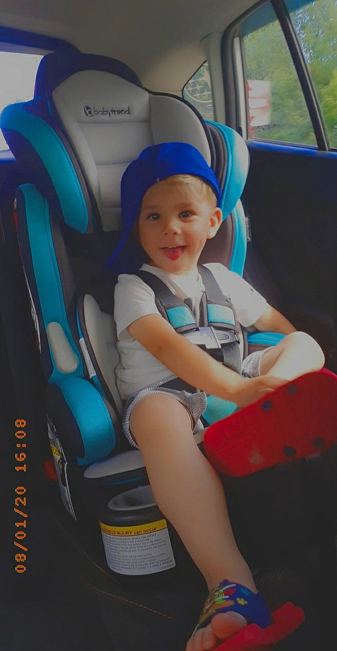 Huntley is registered to the contest to win money with this photo: auto_part, baby, baby_carriage, baby_in_car_seat, baby_products, car, car_seat, child, family_car, headwear, person, product, seat_belt, sitting, smile, toddler, vacation, vehicle