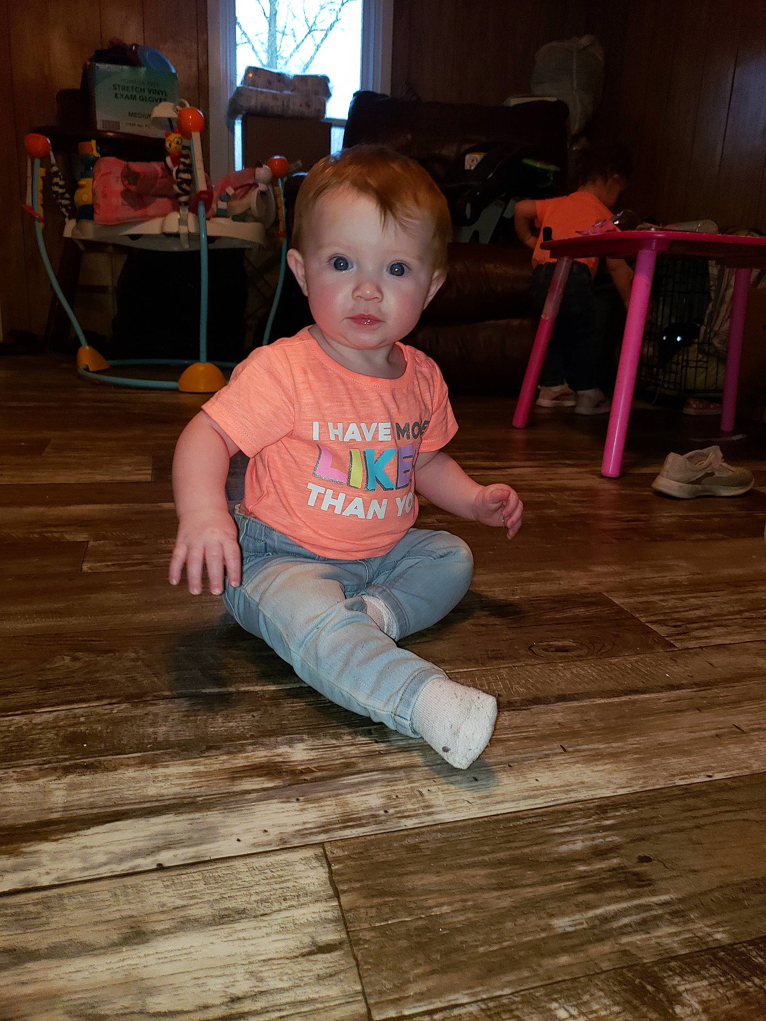 Mia Maze is registered to the contest to win money with this photo: baby, beauty, cheek, child, chin, eye, face, floor, flooring, fun, hardwood, head, leg, person, pink, play, sitting, skin, standing, toddler