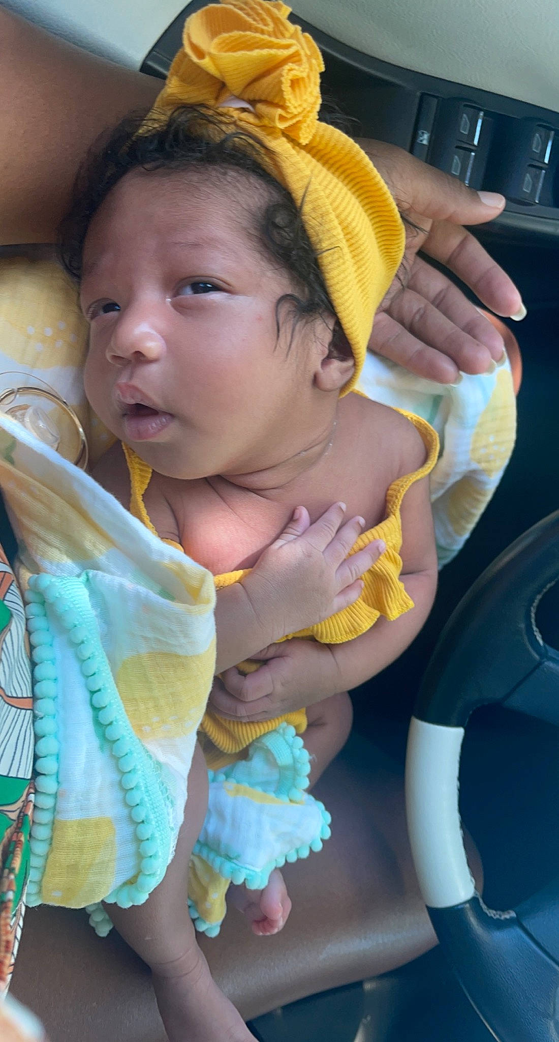 Nyla Zenn is registered to the contest to win money with this photo: baby, baby_carriage, cap, eye, face, finger, fun, green, hand, happy, head, headgear, mouth, neck, person, skin, steering_wheel, thumb, toddler, vehicle_door