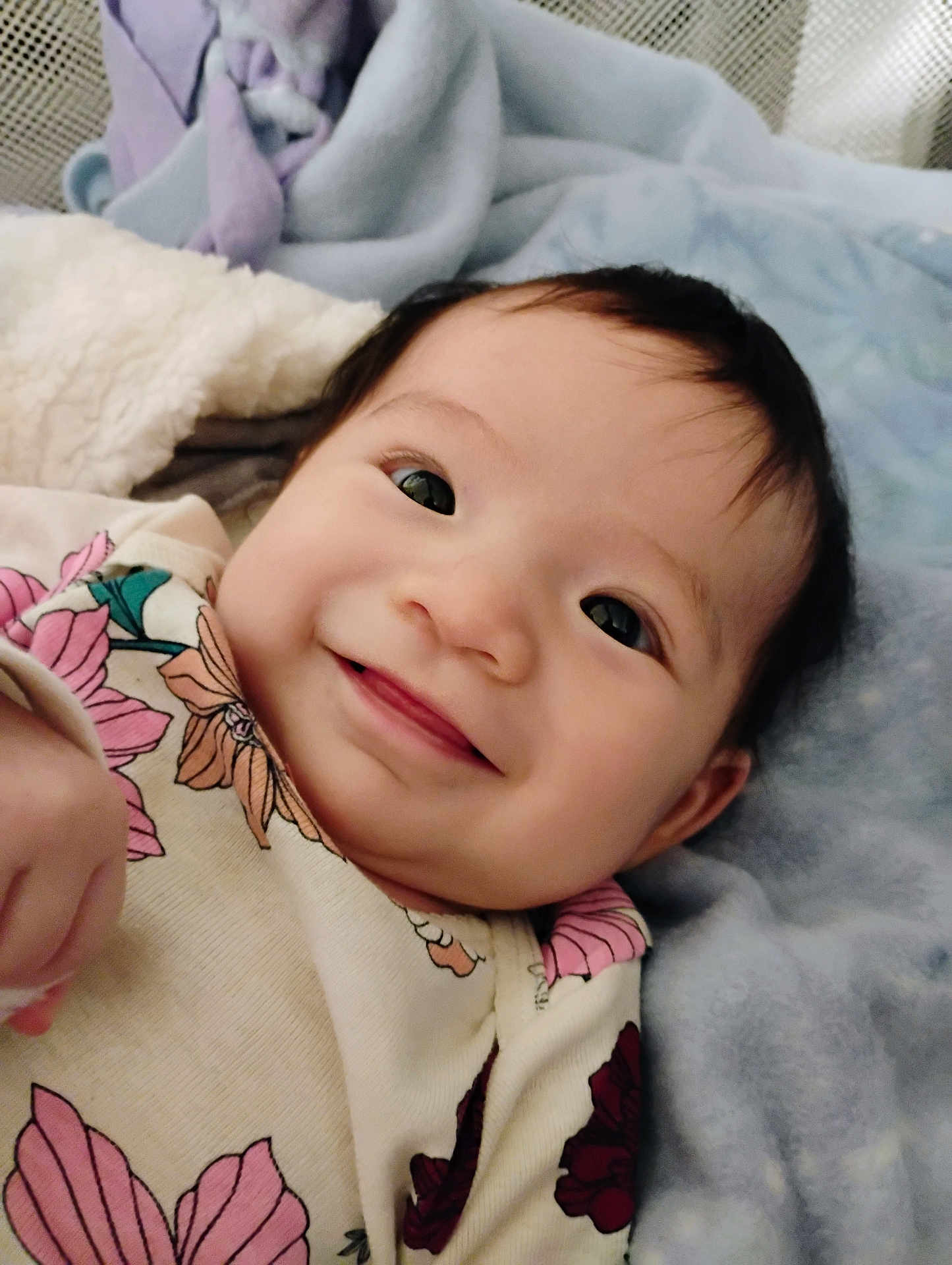 Savahnluv is registered to the contest to win money with this photo: baby, smiling, face, infant, blanket, floral_clothing, cute, lying_down, portrait, child, soft_texture, happy, indoors, young_child, person, closeup, cozy, warm, bed, sleepwear