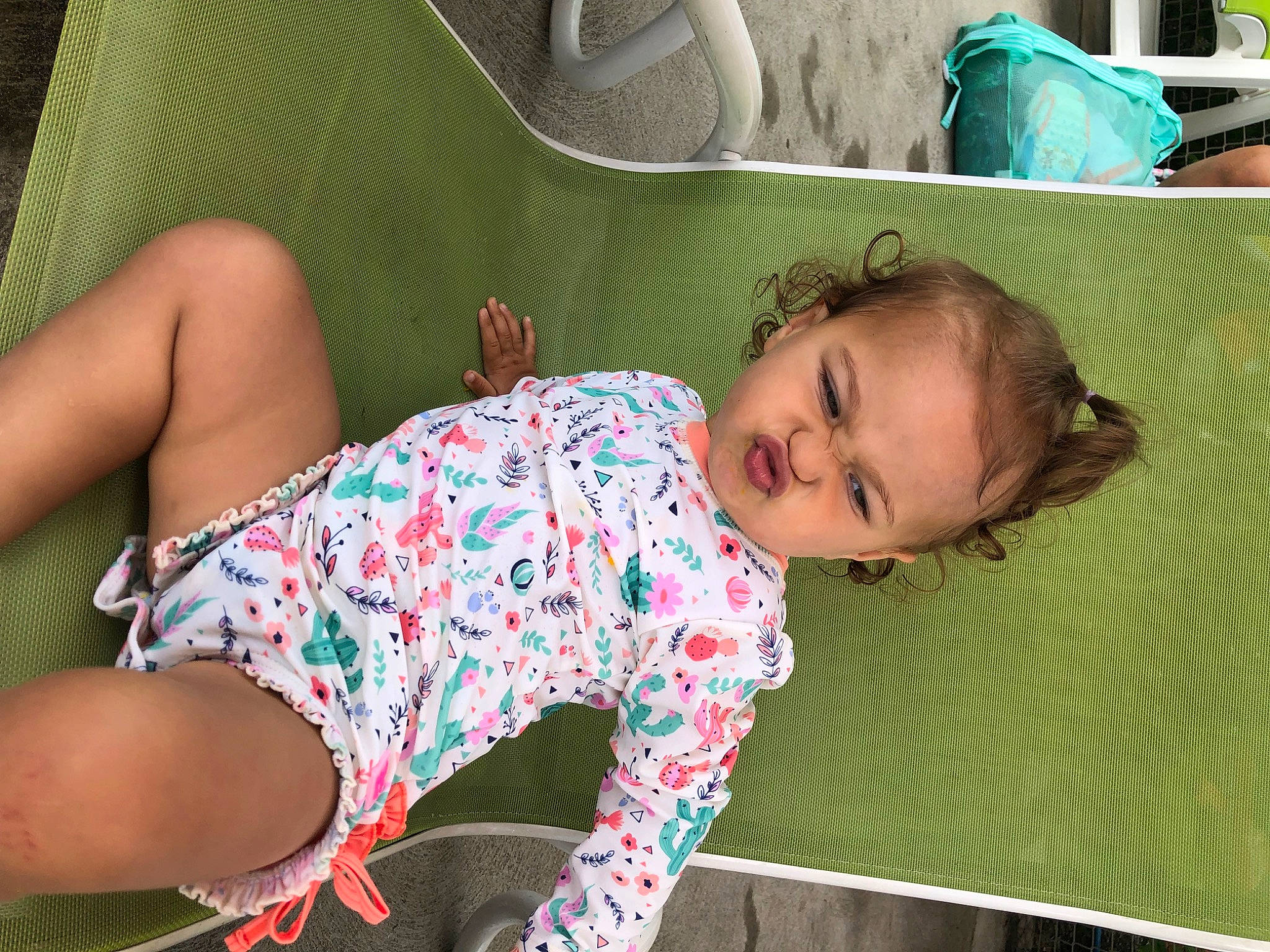 Sage is registered to the contest to win money with this photo: anger, baby, baby_toddler_clothing, child, comfort, foot, fun, grass, green, human_leg, joint, knee, lap, leisure, pattern, person, shorts, sitting, sock, textile