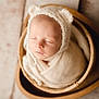 newborn, baby, sleeping, basket, blanket, hat, bear_ears, cozy, wrapped, infant, cute, soft, warm, portrait, indoors, head, peaceful, closeup, child, resting