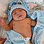 baby, infant, blue_towel, hooded_towel, diaper, bed, white_sheets, cute, child, newborn, skin, sleepy, soft, cozy, blanket, person, hand, indoors, relaxed, towel