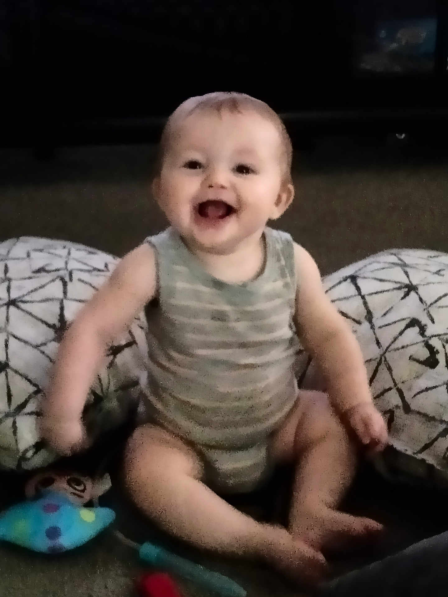 River is registered to the contest to win money with this photo: baby, babylaughing, bodypart, clothing, couch, cushion, face, finger, furniture, hand, happy, head, homedecor, laughing, person, photography, portrait, shorts, sitting, smile
