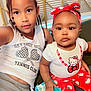 baby, braids, child, clothing, couch, cute, expression, face, family, hand, headband, hello_kitty, indoor, portrait, red_pants, siblings, sitting, toddler, white_tank_top, wipes