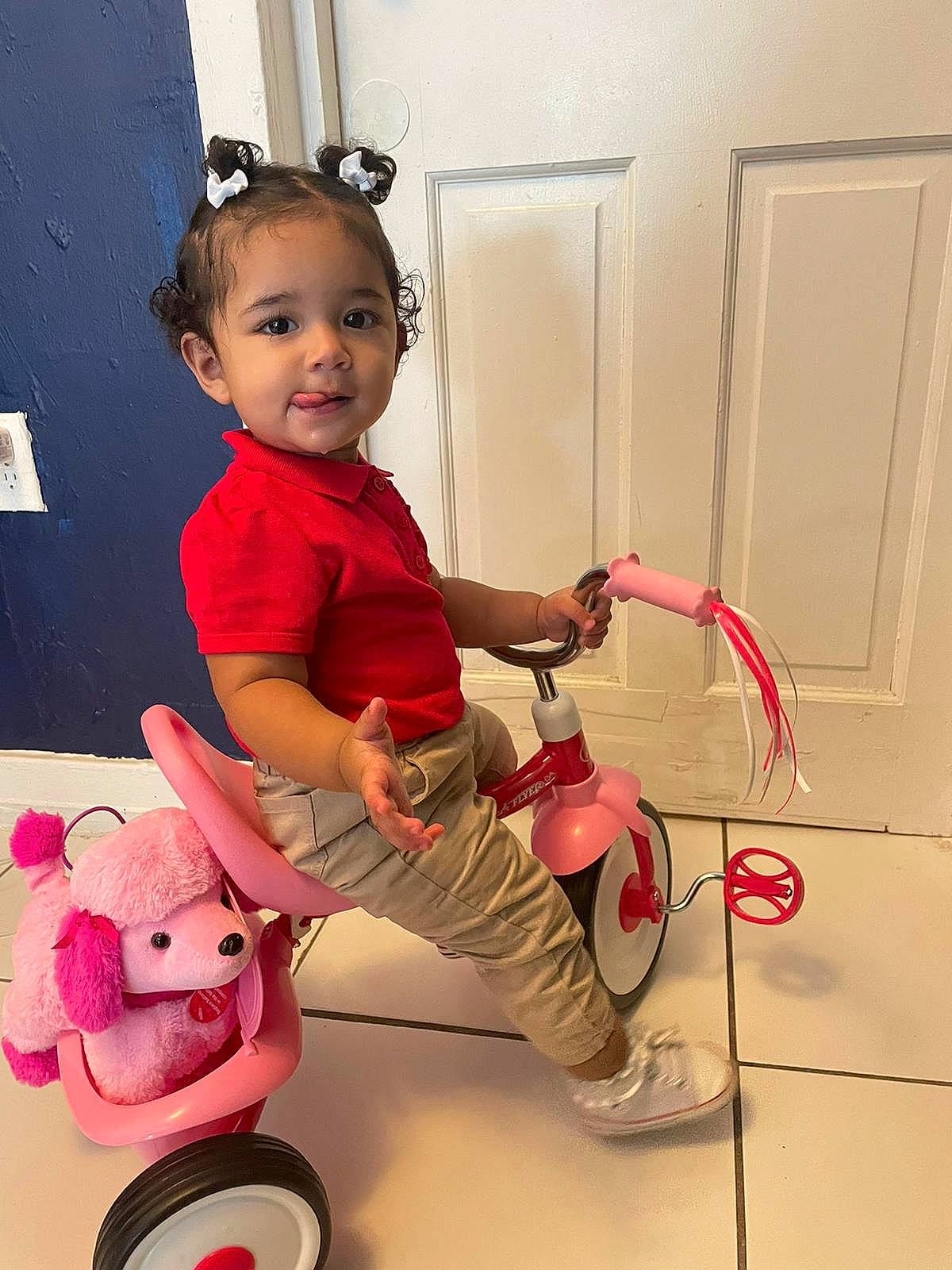 Amira joined the competition — help win amazing prizes! baby, baby_toddler_clothing, child, door, flooring, fun, happy, magenta, person, pink, play, riding_toy, rolling, room, shoe, sitting, sleeve, tire, toddler, vehicle