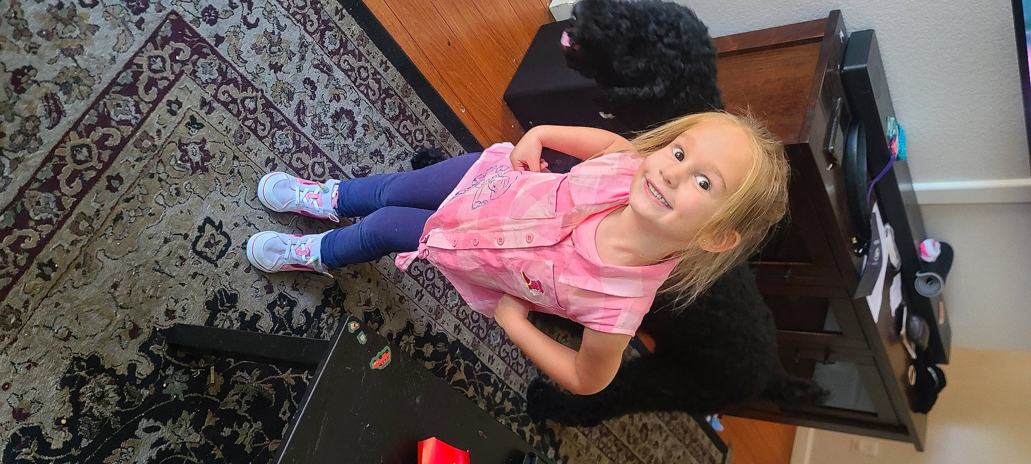 Olivia is registered to the contest to win money with this photo: baby_toddler_clothing, child, floor, flooring, fun, happy, hardwood, human_leg, joy, leisure, magenta, pattern, person, pink, play, room, sitting, smile, sock, thigh