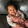 Raelynn joined the competition — help win amazing prizes! baby, babylaughing, clothing, coat, couch, face, furniture, happy, head, homedecor, jacket, laughing, person, photography, portrait, sitting, smile