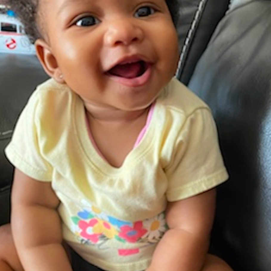 Raelynn joined the competition — help win amazing prizes! accessories, baby, babylaughing, clothing, couch, cushion, face, furniture, happy, head, homedecor, jewelry, laughing, necklace, person, photography, portrait, sitting, smile, t_shirt