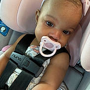 Kayomi joined the competition — help win amazing prizes! adorable, baby, black_straps, car, car_seat, child, child_safety, close_up, clothing, cute, eyes, face, headband, infant, pacifier, pink_bow, portrait, safety, seat_belt, straps