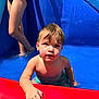 toddler, child, water, swimwear, inflatable_pool, summer, sunlight, play, water_droplets, blue, red, skin, hair, hand, legs, person, outdoor, fun, vacation, pool
