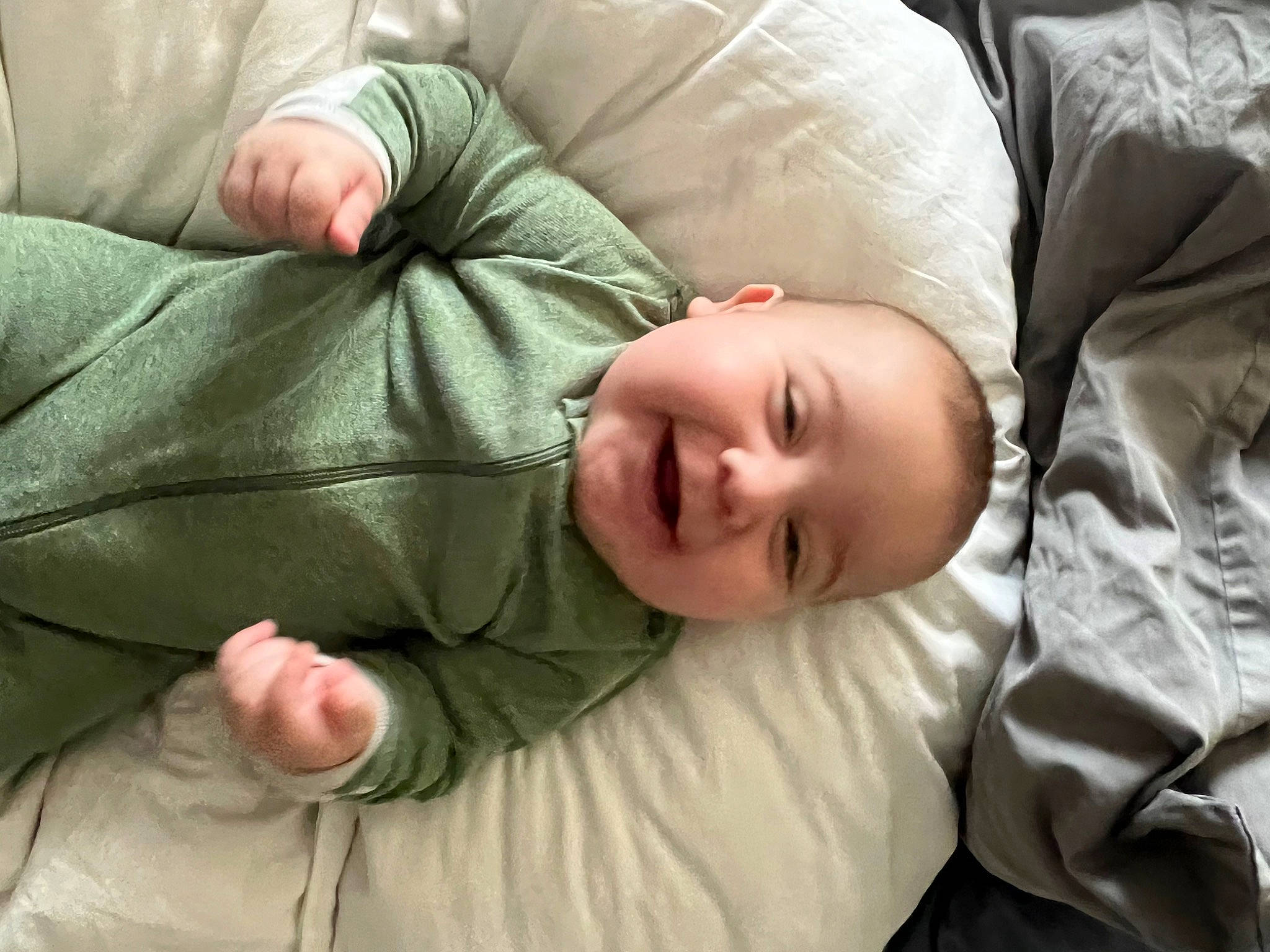 Kaleb joined the competition — help win amazing prizes! baby, baby_toddler_clothing, child, comfort, facial_expression, grass, linens, person, sitting, sleeve, smile, toddler