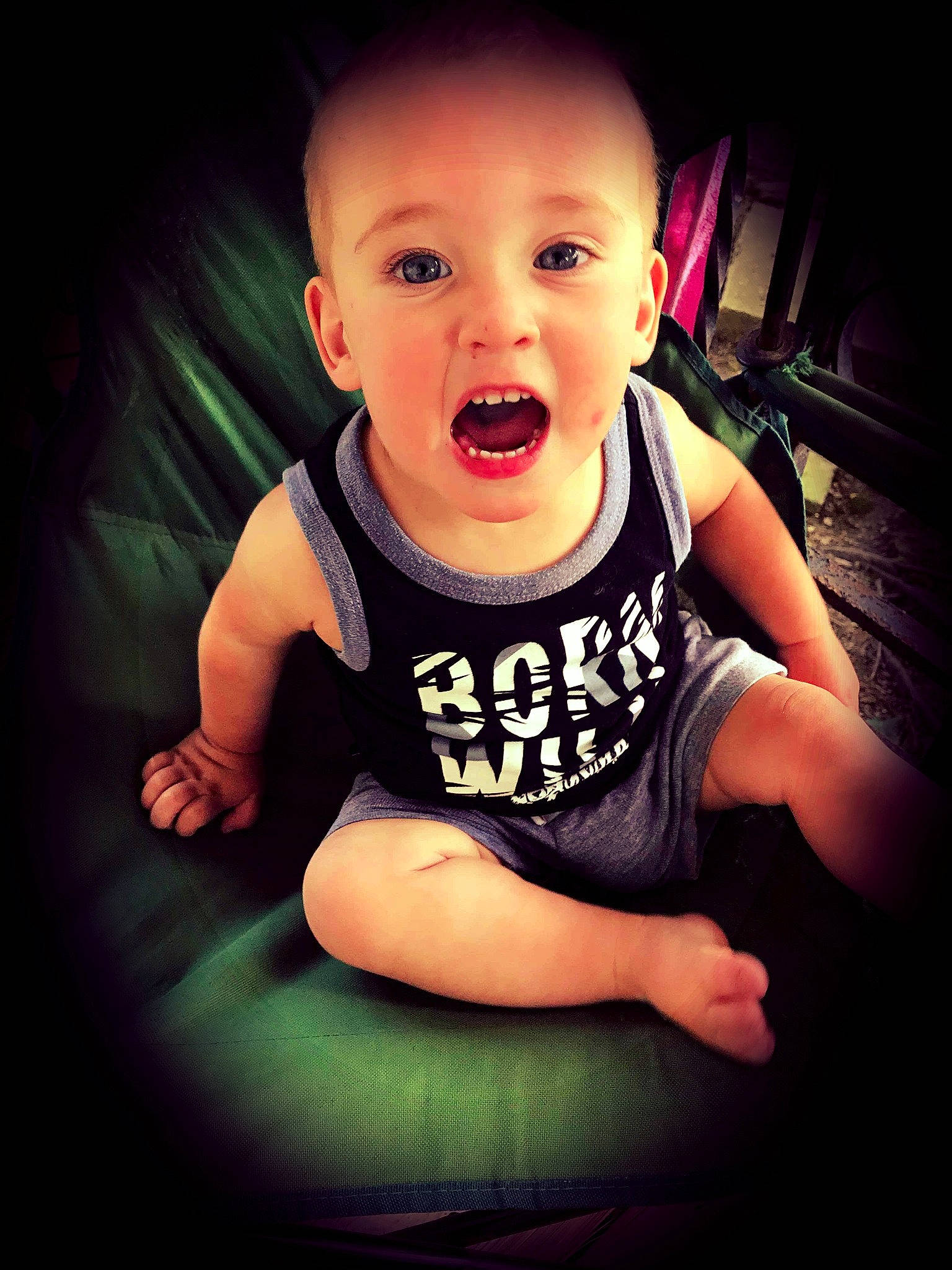 Jase is registered to the contest to win money with this photo: arm, baby, cheek, child, chin, cool, eye, face, facial_expression, fun, hand, head, mouth, muscle, nose, person, sitting, skin, smile, t_shirt