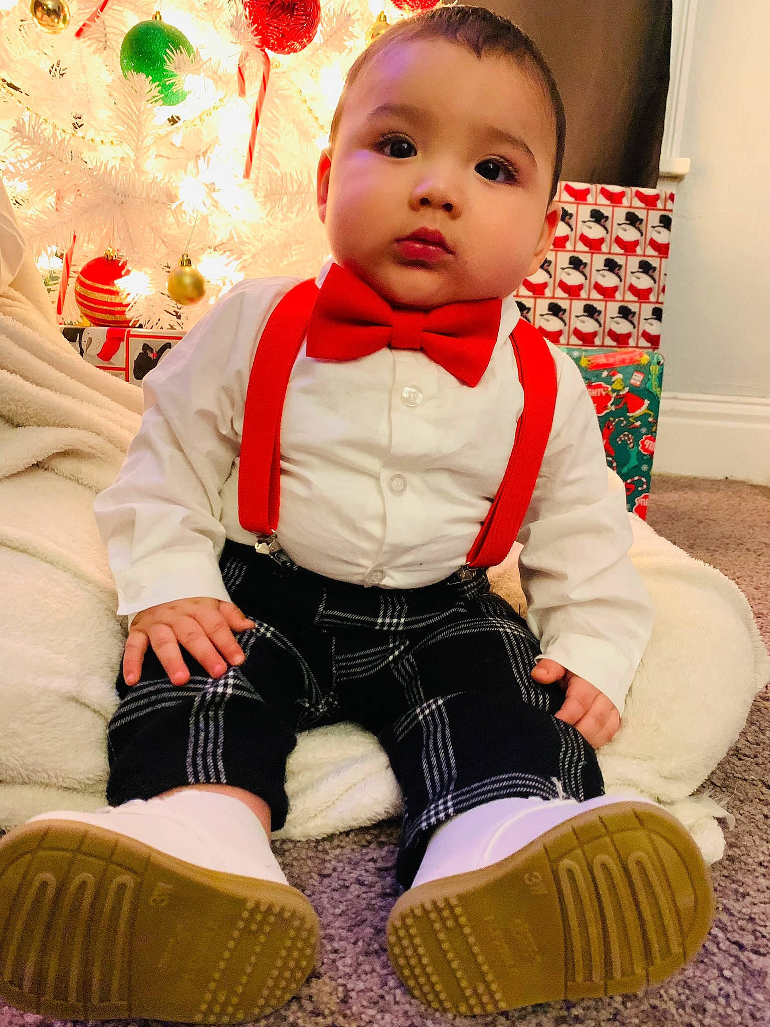 Nikolas is registered to the contest to win money with this photo: baby, baby_toddler_clothing, cheek, child, dress, face, green, happy, head, human_body, knee, pattern, person, red, sitting, skin, sleeve, sock, thigh, toddler