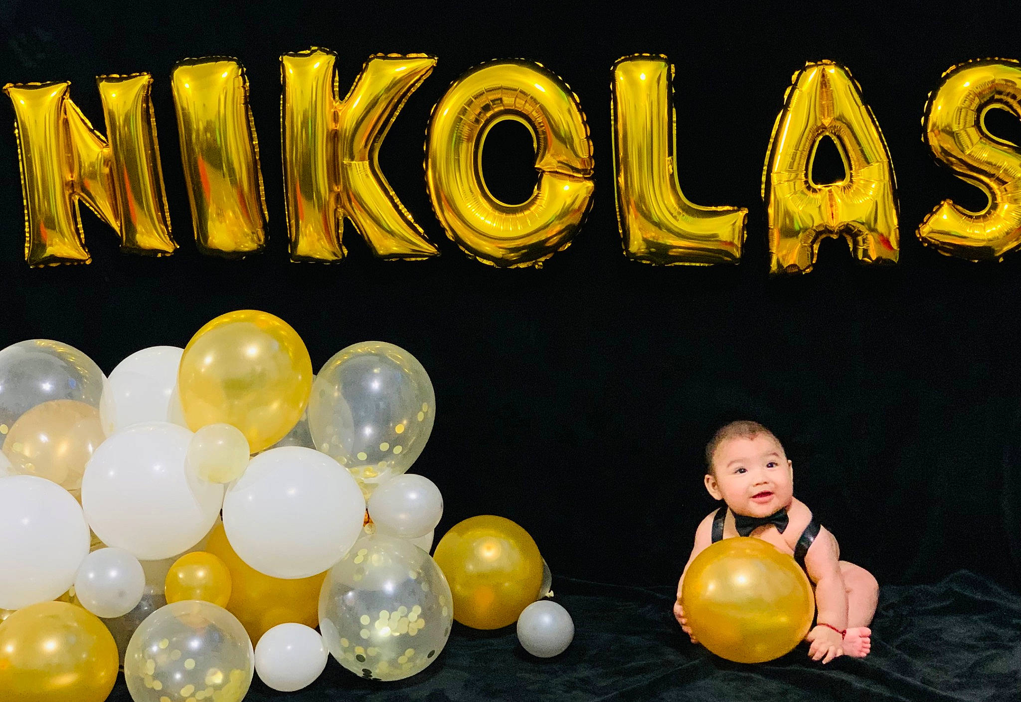 Nikolas is registered to the contest to win money with this photo: arch, balloon, event, font, fun, graphics, happy, leisure, logo, party, party_supply, person, sphere, toddler, toy, yellow