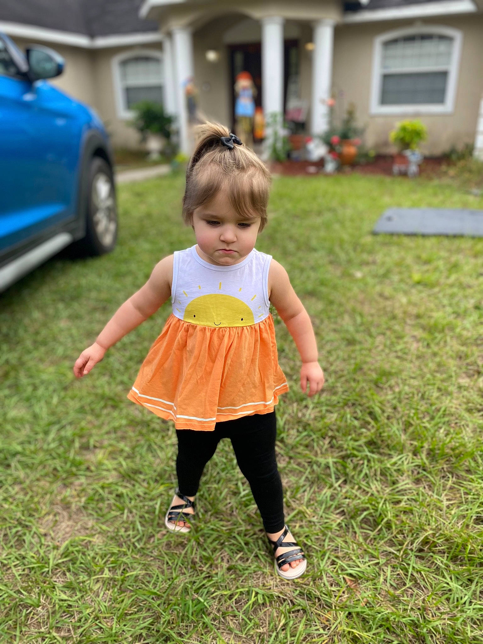 Ileanna is registered to the contest to win money with this photo: baby_toddler_clothing, car, child, footwear, fun, grass, happy, lawn, leisure, people_in_nature, person, plant, recreation, sandal, shoe, sneakers, t_shirt, tire, toddler, vehicle