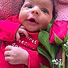 Leilani joined the competition — help win amazing prizes! baby, infant, red_clothing, blanket, rose, flower, green_leaves, hand, face, portrait, cute, newborn, skin, eyes, mouth, lying_down, cozy, soft_texture, close_up, happy