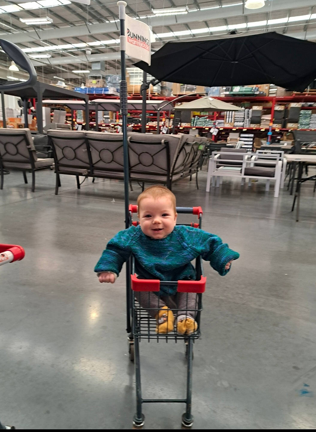 Leroy is registered to the contest to win money with this photo: baby_carriage, baby_products, chair, child, city, engineering, event, flooring, fun, joy, leisure, machine, person, product, recreation, sitting, smile, standing, t_shirt, toddler