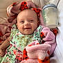 baby, smiling, blanket, ladybug_pattern, floral_outfit, milk_bottle, infant, cozy, happy, cute, lying_down, pink, white, soft, child, portrait, indoors, bottle, feeding, resting