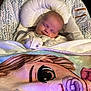 baby, sleeping, blanket, baby_seat, cartoon, pacifier, cozy, infant, face, soft, cushion, clothing, indoors, child, cute, resting, young, comfort, portrait, peaceful
