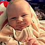 baby, infant, smile, face, hands, onesie, cozy, blanket, closeup, indoors, child, cute, soft_lighting, portrait, happy, newborn, skin, head, expression, warm