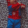 adorable, baby, blanket, blue, child, costume, cute, face, feet, hands, headwear, indoors, infant, leopard_print, lying_down, pattern, portrait, red, smiling, spiderman_costume