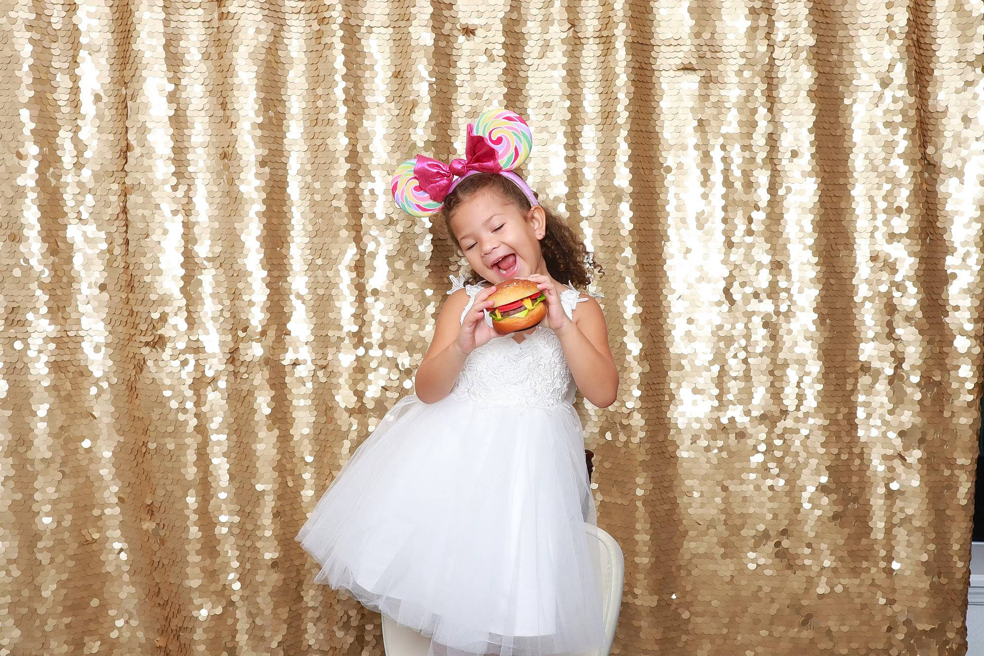 Isabella is registered to the contest to win money with this photo: bridal_accessory, bridal_clothing, bridal_party_dress, dress, event, facial_expression, flash_photography, flower, fun, hair_accessory, hairstyle, happy, hat, headpiece, person, petal, pink, smile, textile, toddler