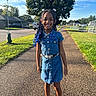 child, girl, smiling, outdoor, portrait, denim_dress, braids, hair_accessories, blue_hair, sunglasses, belt, sandals, fashion, park, path, suburban, trees, sunny, playground, full_body