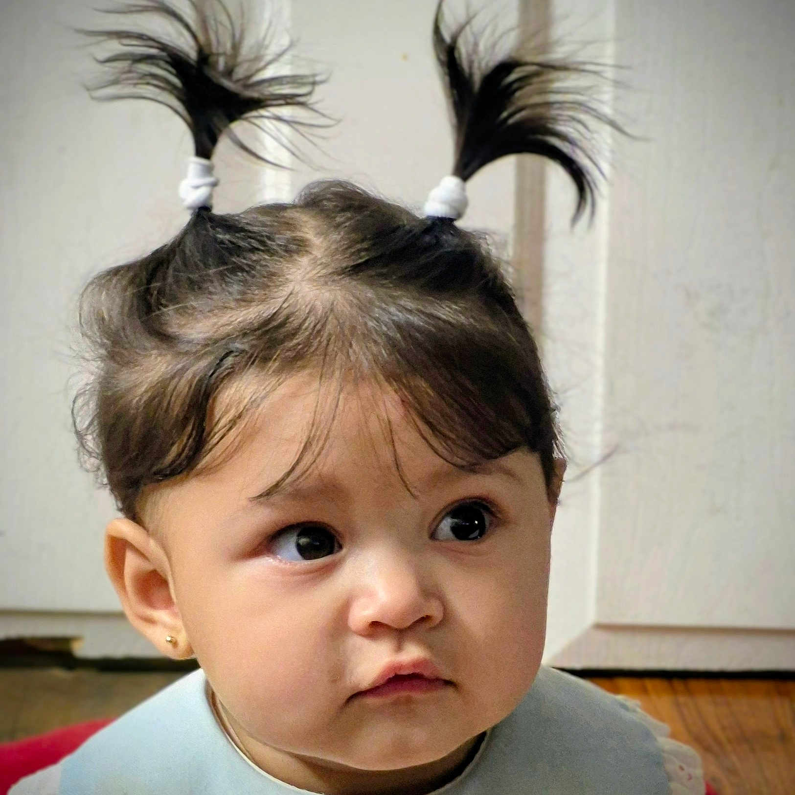 Ari Natasha is registered to the contest to win money with this photo: baby, baby_girl, child, closeup, clothing, curious, cute, earrings, expression, face, hair, head, indoors, looking_away, person, pigtails, portrait, skin, toddler, young_child