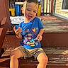 child, boy, smiling, outdoor, steps, wood, sunlight, tshirt, shorts, happy, porch, playful, bottle, daylight, casual, fun, summer, young, person, sitting