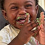 toddler, child, smiling, happy, face, hands, cake, crumbs, messy, clapping, celebration, food, cute, closeup, indoor, person, curly_hair, white_shirt, joy, playful