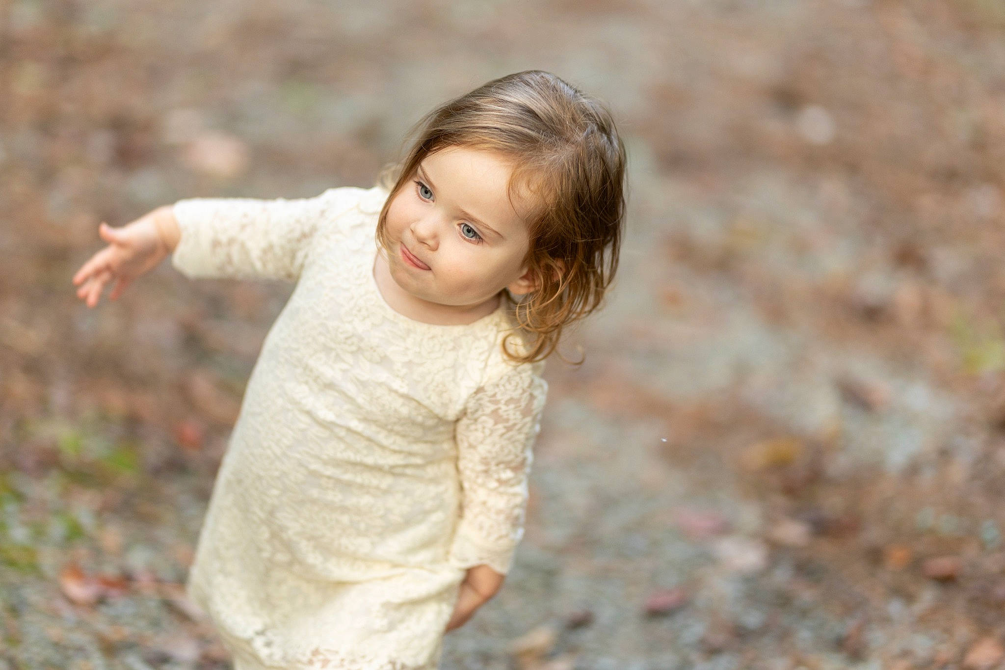 Milana is registered to the contest to win money with this photo: chin, dress, eye, face, facial_expression, flash_photography, gesture, grass, hair, hairstyle, happy, iris, lip, people_in_nature, person, plant, skin, sleeve, standing, toddler