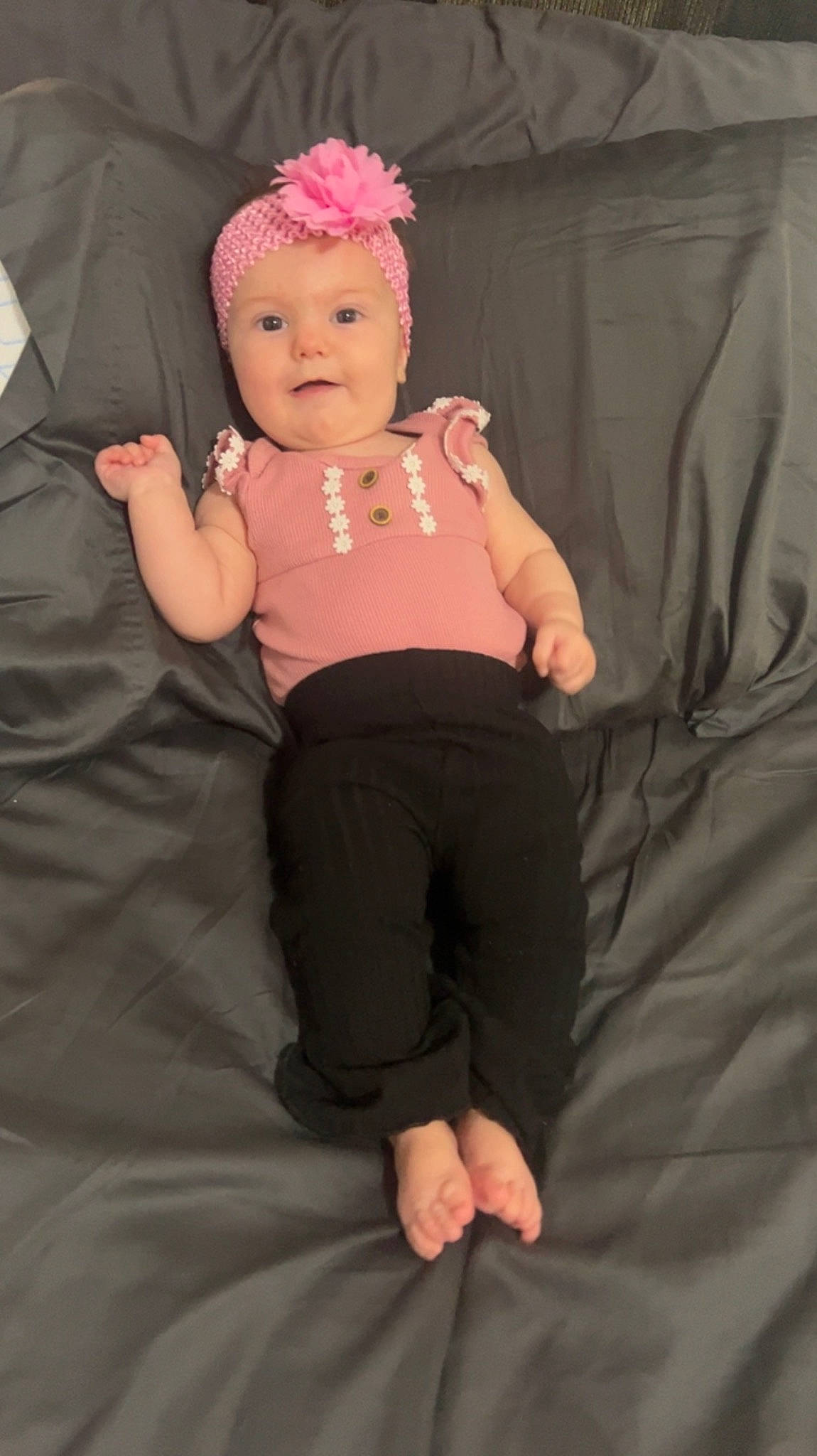 Mavis is registered to the contest to win money with this photo: baby, baby_toddler_clothing, cap, chin, comfort, eye, finger, gesture, hair, happy, headwear, helmet, human_body, lip, person, pink, shorts, sleeve, smile, textile
