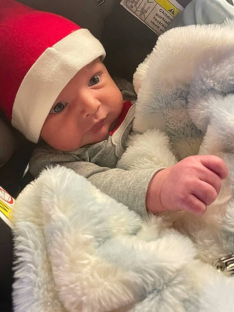 Cameron is registered to the contest to win money with this photo: baby, baby_sleeping, baby_toddler_clothing, beanie, cap, child, comfort, companion_dog, felidae, fur, fur_clothing, headwear, knit_cap, linens, nap, parka, person, polar_fleece, skin, toddler