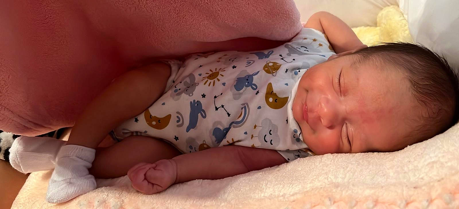 Abraham is registered to the contest to win money with this photo: baby, baby_sleeping, baby_toddler_clothing, bedtime, cheek, chest, child, close_up, comfort, facial_expression, finger, linens, mammal, mouth, organ, person, room, skin, thumb, toddler