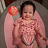 baby, child, infant, smiling, pink_clothing, baby_seat, hair_clip, indoor, person, cute, happy, face, sitting, onesie, young_child, 5_months, skin, furniture, cushion, portrait