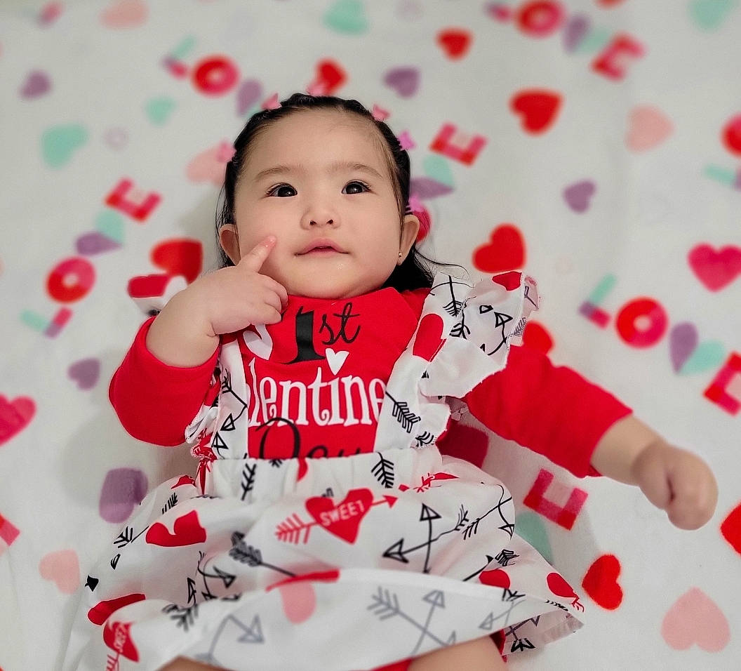 Sophia joined the competition — help win amazing prizes! arm, baby_toddler_clothing, carmine, child, collar, face, facial_expression, finger, font, fun, gesture, happy, headwear, pattern, person, pink, sitting, sleeve, smile, t_shirt