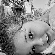 Amalya participe au concours pour gagner de l'argent avec cette photo : black_and_white, candid, cheek, child, close_up, earring, expression, eye, face, hair, happy, nose, outdoor, person, portrait, resting, skin, smile, texture, young