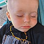 Wayne a rejoint le concours — aidez-le/la à gagner de superbes lots ! beaded_necklace, black_shirt, blanket, blond_hair, casual_clothing, child, closeup, eyelashes, face, hammock, infant, outdoor, peaceful, portrait, relaxation, resting, sleeping, soft_light, text_clothing, toddler