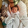 newborn, baby, infant, child, sleeping, awake, face, smiling, striped_outfit, blanket, plush_toy, giraffe, crib, cozy, portrait, indoors, nursery, pacifier, textile, arms_up