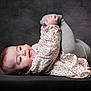 Mencia a rejoint le concours — aidez-le/la à gagner de superbes lots ! baby, background, child, clothing, cute, feet, floral_pattern, hands, happy, indoors, infant, leggings, lying_down, person, playful, portrait, smiling, soft_lighting, studio, young