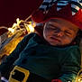 baby, basket, blanket, child, christmas_elf, costume, cozy, cute, face, fairy_lights, festive, hat, holiday, indoors, infant, plaid, resting, sleeping, soft, warm_lighting